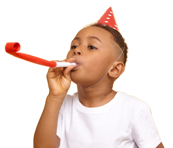 Young Child In A Party Hat Blowing A Party Blower